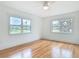 Bedroom featuring hardwood floors, a ceiling fan and two large windows at 1510 Live Oak St, New Smyrna Beach, FL 32168