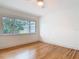 Bright bedroom featuring hardwood floors and a large window at 1510 Live Oak St, New Smyrna Beach, FL 32168