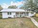 Inviting single-story home featuring a well-manicured front lawn and a sidewalk leading to the charming front porch at 1510 Live Oak St, New Smyrna Beach, FL 32168