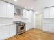 Well-lit kitchen featuring white cabinets, stainless steel appliances, and a modern backsplash at 1510 Live Oak St, New Smyrna Beach, FL 32168