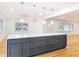 Bright open kitchen featuring a large island with pendant lights and hardwood floors at 1510 Live Oak St, New Smyrna Beach, FL 32168