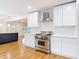 Bright kitchen with stainless steel range, white cabinetry, and modern backsplash design at 1510 Live Oak St, New Smyrna Beach, FL 32168