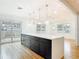 Bright open kitchen featuring a large island, modern pendant lights, and hardwood floors at 1510 Live Oak St, New Smyrna Beach, FL 32168