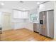 Well-lit kitchen featuring white cabinetry, stainless steel appliances, and attractive backsplash at 1510 Live Oak St, New Smyrna Beach, FL 32168