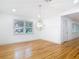 Living room featuring hardwood floors and natural light from side yard and front door at 1510 Live Oak St, New Smyrna Beach, FL 32168