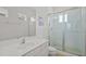 Bathroom featuring a glass shower, a vanity sink, and a window for natural light at 1511 Fairview Cir, Kissimmee, FL 34747