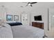 Bright bedroom features a ceiling fan, two beds, TV, and access to the bathroom at 1511 Fairview Cir, Kissimmee, FL 34747