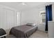 Bright bedroom features neutral tones, a ceiling fan, closet, and natural light from the window at 1511 Fairview Cir, Kissimmee, FL 34747