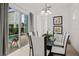 Bright dining room with a modern chandelier, a glass table, and sliding glass doors leading to the pool area at 1511 Fairview Cir, Kissimmee, FL 34747