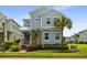 Charming two-story home with light blue siding, stone accents, and a well-manicured lawn at 1511 Fairview Cir, Kissimmee, FL 34747