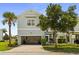 Charming two-story home with a garage, manicured lawn, and mature landscaping at 1511 Fairview Cir, Kissimmee, FL 34747