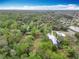 Aerial shot showcases sprawling greenery, mature trees, and a shed nestled within a charming neighborhood at 15523 Old Cheney Hwy, Orlando, FL 32828