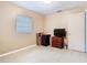 Small bedroom with tile flooring, one window, and filled with furniture and cardboard boxes at 15523 Old Cheney Hwy, Orlando, FL 32828