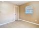 This simple bedroom has neutral walls, tiled floors, a window with blinds, and a closet at 15523 Old Cheney Hwy, Orlando, FL 32828