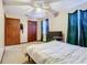 Relaxing bedroom with a large window with curtains, closet, and television at 15523 Old Cheney Hwy, Orlando, FL 32828