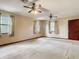 Bedroom featuring carpet floors, a ceiling fan, and two windows with curtains at 15523 Old Cheney Hwy, Orlando, FL 32828