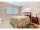 Cozy bedroom featuring tile flooring, a bed, and a nightstand with a lamp at 15523 Old Cheney Hwy, Orlando, FL 32828