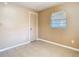 Small empty bedroom featuring a window, tiled floor, and neutral paint at 15523 Old Cheney Hwy, Orlando, FL 32828