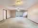 Bright, carpeted living room featuring sliding glass doors and a ceiling fan at 15523 Old Cheney Hwy, Orlando, FL 32828