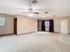 Large living room with plush carpet, ceiling fan, and lots of space at 15523 Old Cheney Hwy, Orlando, FL 32828