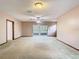 Spacious living room with sliding glass doors, carpet, and neutral paint at 15523 Old Cheney Hwy, Orlando, FL 32828