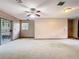 Large living room featuring a sliding glass door, a window and a ceiling fan at 15523 Old Cheney Hwy, Orlando, FL 32828