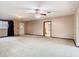 Living room with ceiling fan, entrance door, and a view through the doorway to another room at 15523 Old Cheney Hwy, Orlando, FL 32828