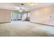 Open-concept living room featuring sliding glass doors, ceiling fan, and light-colored walls at 15523 Old Cheney Hwy, Orlando, FL 32828