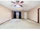 Spacious living room with a ceiling fan, window, and a white door to the entrance at 15523 Old Cheney Hwy, Orlando, FL 32828