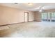 A bright living room with ceiling fan, tile fireplace, white door and sliding glass doors at 15523 Old Cheney Hwy, Orlando, FL 32828