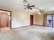 Open living room with multiple ceiling fans, doorway access, and sliding glass doors at 15523 Old Cheney Hwy, Orlando, FL 32828