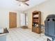 Office space with tiled floor, built-in bookcase, and neutral paint at 15523 Old Cheney Hwy, Orlando, FL 32828