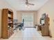 A home office featuring tile floors, a ceiling fan, a computer desk, and ample storage at 15523 Old Cheney Hwy, Orlando, FL 32828