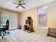 Tile flooring and sliding glass door in a room with desk and a ceiling fan at 15523 Old Cheney Hwy, Orlando, FL 32828
