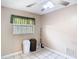 A small room with tile flooring, a window, and two trash cans at 15523 Old Cheney Hwy, Orlando, FL 32828