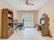 A room with desk, ceiling fan, tile flooring and sliding glass door at 15523 Old Cheney Hwy, Orlando, FL 32828