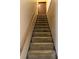 Carpeted staircase with wooden railing leading to the upper level of the home at 15523 Old Cheney Hwy, Orlando, FL 32828