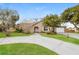 Charming single-story home featuring a welcoming front yard and curved driveway at 1582 Darlington Ave, Deltona, FL 32725