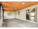 Enclosed patio featuring a wood paneled ceiling with recessed lighting and concrete flooring at 1582 Darlington Ave, Deltona, FL 32725