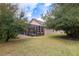 Lush backyard featuring a screened-in patio with a pool and surrounding mature trees at 1726 Brackenhurst Pl, Lake Mary, FL 32746