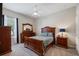 Cozy bedroom with wood furniture and window with blinds lets in a lot of natural light at 1726 Brackenhurst Pl, Lake Mary, FL 32746