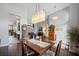 Formal dining area with modern chandelier and wood floors offers elegant space for entertaining at 1726 Brackenhurst Pl, Lake Mary, FL 32746