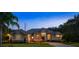 Beautiful single-story home featuring manicured landscaping, a tile roof, and a welcoming stone-accented facade at 1726 Brackenhurst Pl, Lake Mary, FL 32746