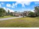 Well-manicured front lawn and brick driveway leading to a lovely home with a three-car garage at 1726 Brackenhurst Pl, Lake Mary, FL 32746