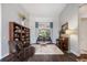 Cozy living room featuring a bookshelf, recliner, couch, piano, and bright window at 1726 Brackenhurst Pl, Lake Mary, FL 32746