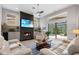 Bright and airy living room features a fireplace, a ceiling fan, and sliding glass doors leading to the outdoor space at 1726 Brackenhurst Pl, Lake Mary, FL 32746