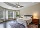 Spacious main bedroom featuring tray ceiling, ceiling fan, and screened window views at 1726 Brackenhurst Pl, Lake Mary, FL 32746