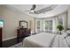 Main bedroom with ceiling fan, dresser, and plenty of natural light from screened windows at 1726 Brackenhurst Pl, Lake Mary, FL 32746