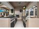 Spacious outdoor kitchen with built-in grill, counter space, and a view of the screened-in patio at 1726 Brackenhurst Pl, Lake Mary, FL 32746