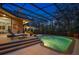 Evening shot of backyard pool with screened enclosure offers privacy and outside eating area at 1726 Brackenhurst Pl, Lake Mary, FL 32746